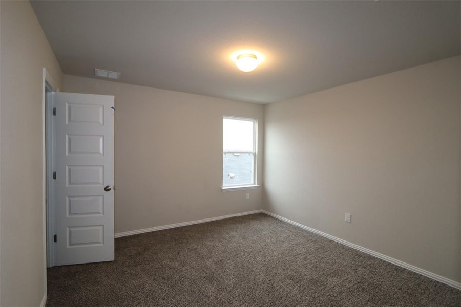 Unfurnished room with dark colored carpet