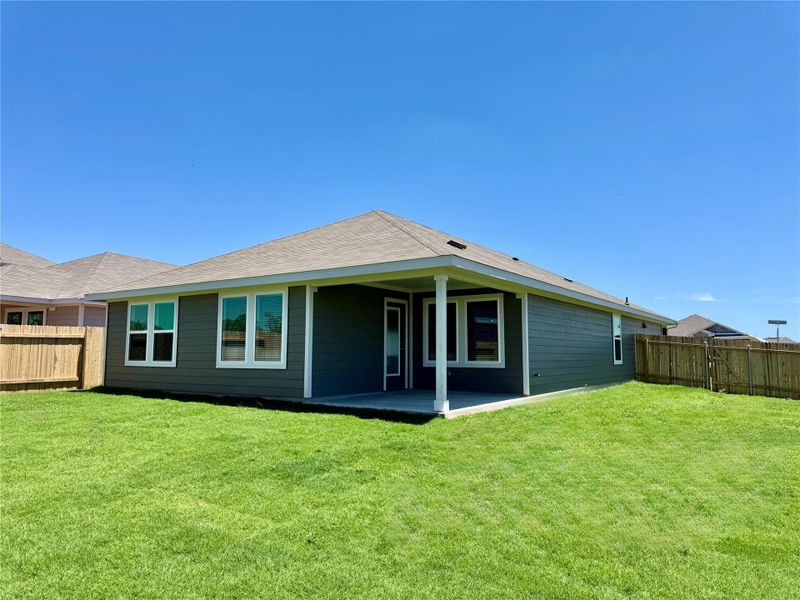 Rear view of house featuring a patio and a fenced backyard