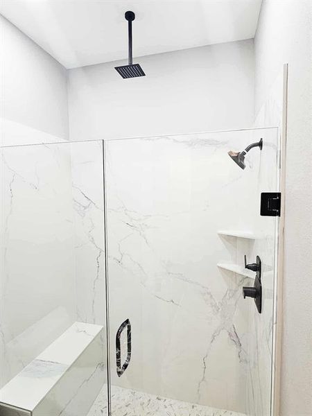 Master shower w/ quartz, built in bench, and rain head faucet.
