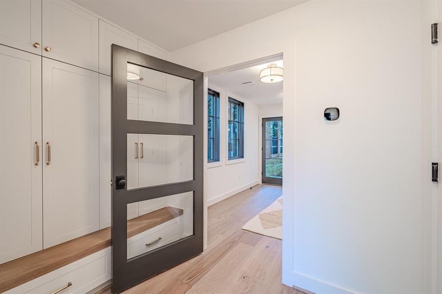Hallway with light wood finished floors and baseboards Hallway with light wood finished floors and baseboards