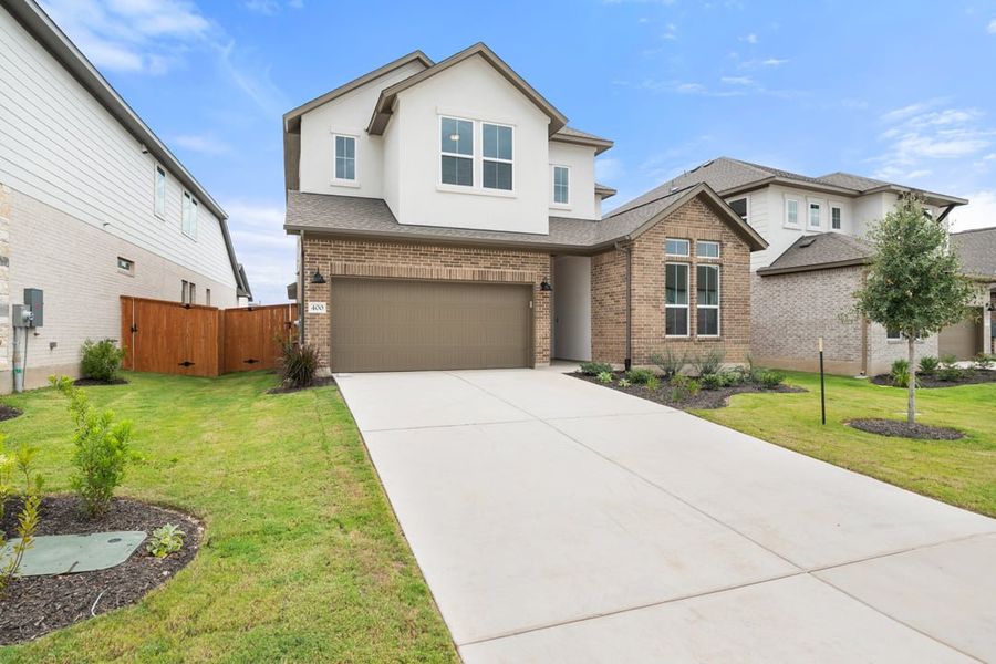 Front exterior of a new home in Arbor Collection at Lariat, Liberty Hill, TX, highlighting curb appeal (Image 24). Front exterior of a new home in Arbor Collection at Lariat, Liberty Hill, TX, highlighting curb appeal (Image 24).