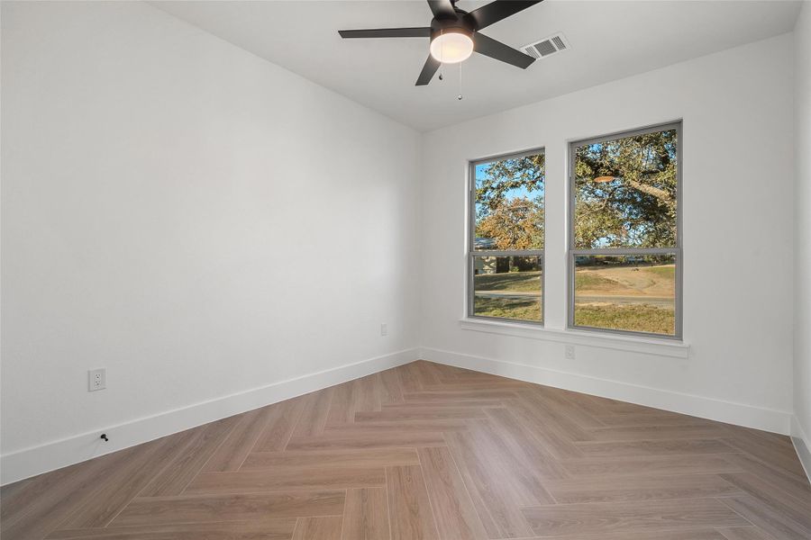 Spare room featuring baseboards and ceiling fan
