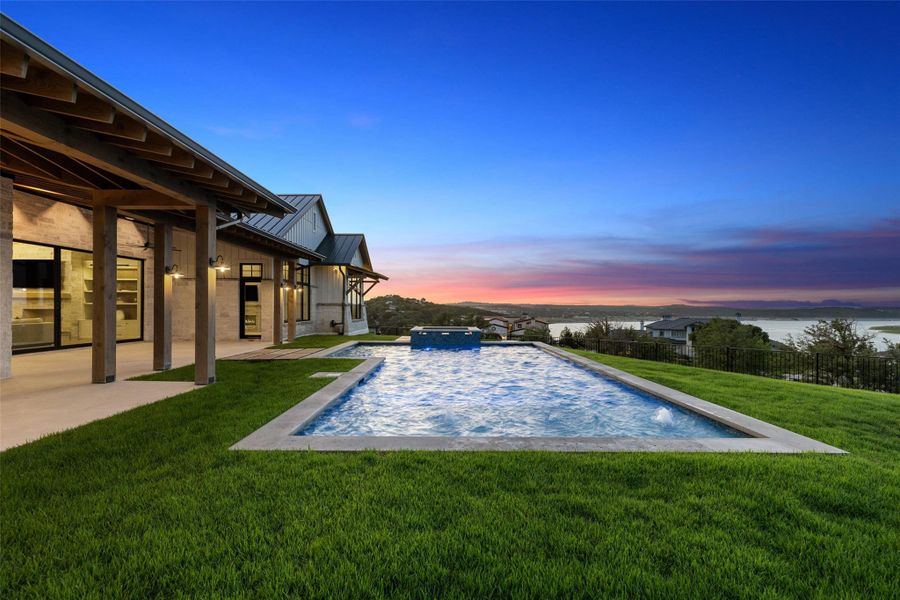 View of pool featuring a fenced backyard, a patio, and a pool with connected hot tub