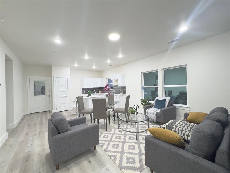 Living room with light hardwood / wood-style floors