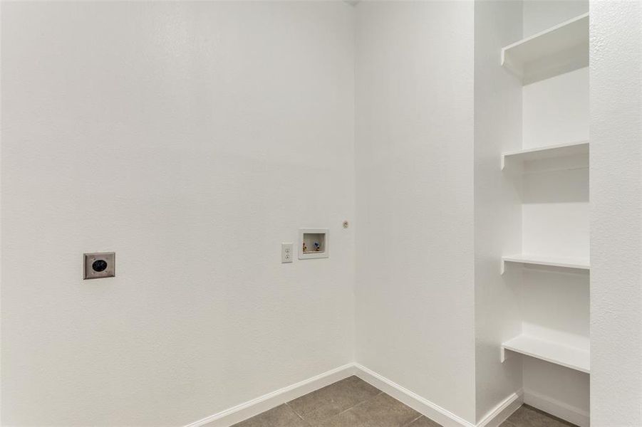 Laundry area with tile patterned floors, electric dryer hookup, and hookup for a washing machine