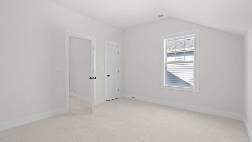 Superior comfort in this light-filled bedroom with plush carpeting and thoughtfully placed large windows