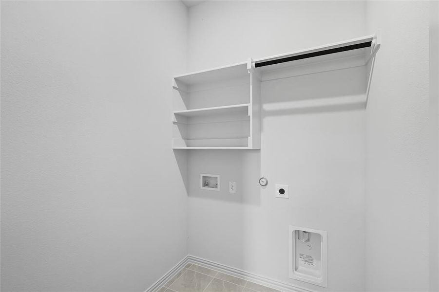Laundry area with light tile patterned floors, washer hookup, hookup for an electric dryer, and hookup for a gas dryer Laundry area with light tile patterned floors, washer hookup, hookup for an electric dryer, and hookup for a gas dryer