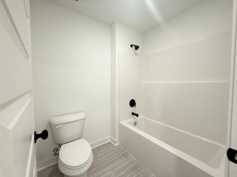 Bathroom with toilet and shower / tub combination