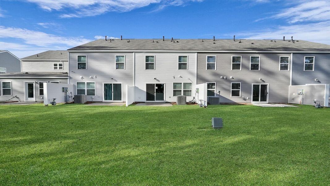 Exterior details and patio area of a home in Pine Hills Townhomes at Cane Bay, Summerville (Image 23). Exterior details and patio area of a home in Pine Hills Townhomes at Cane Bay, Summerville (Image 23).