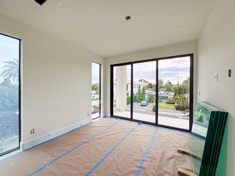 (as of April 8, 2026) the 2nd guest bedroom on the second level features also features full-height pictures windows along with access to a shared patio balcony