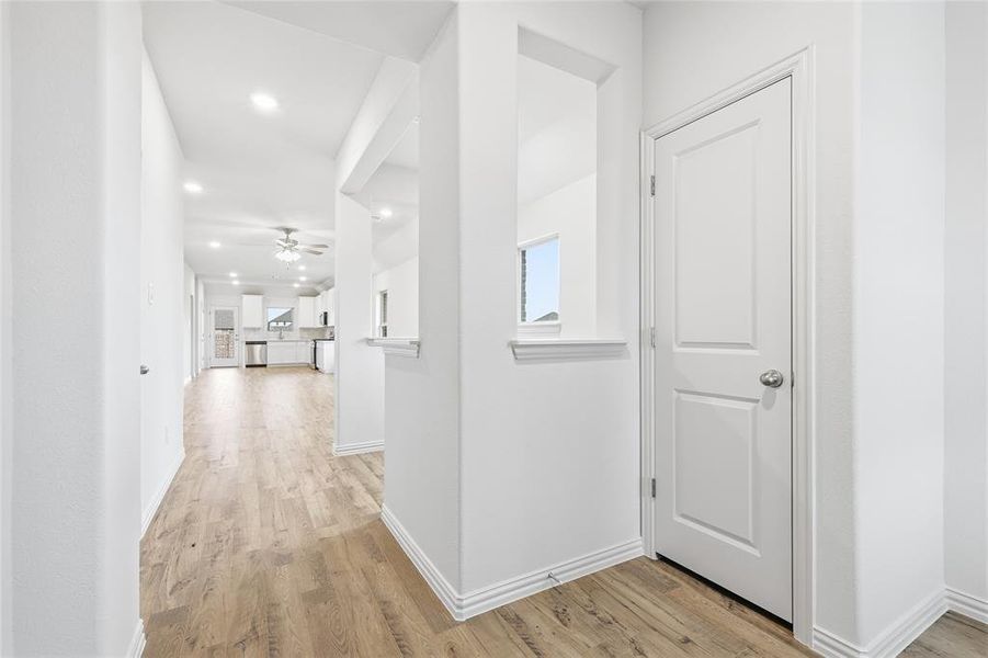 Hallway featuring light wood-style floors and recessed lighting