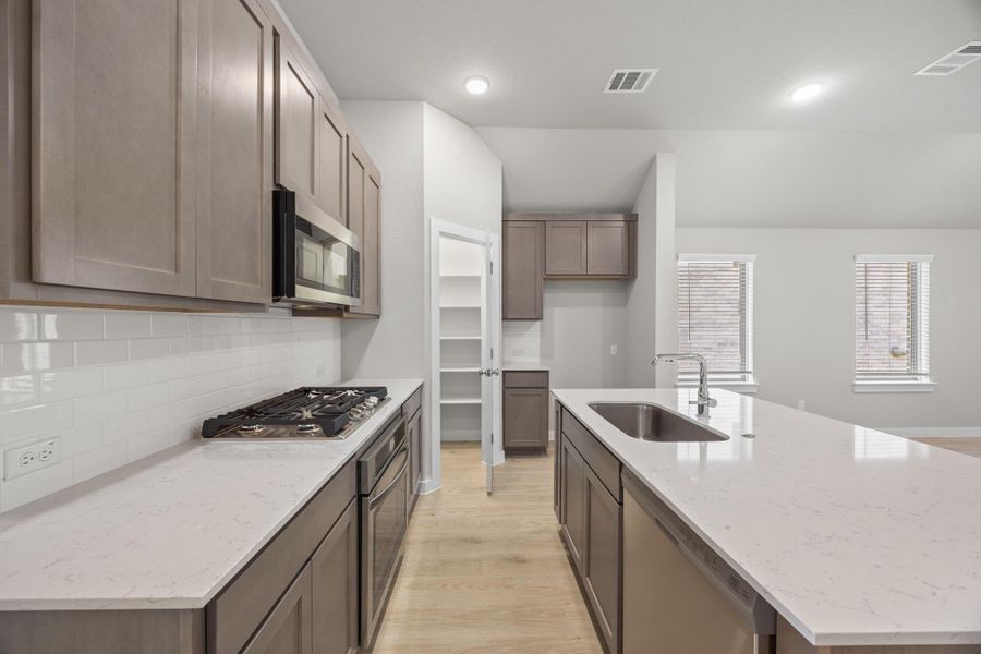 Kitchen in the Cypress home plan by Trophy Signature Homes - REPRESENTATIVE PHOTO Kitchen in the Cypress home plan by Trophy Signature Homes - REPRESENTATIVE PHOTO