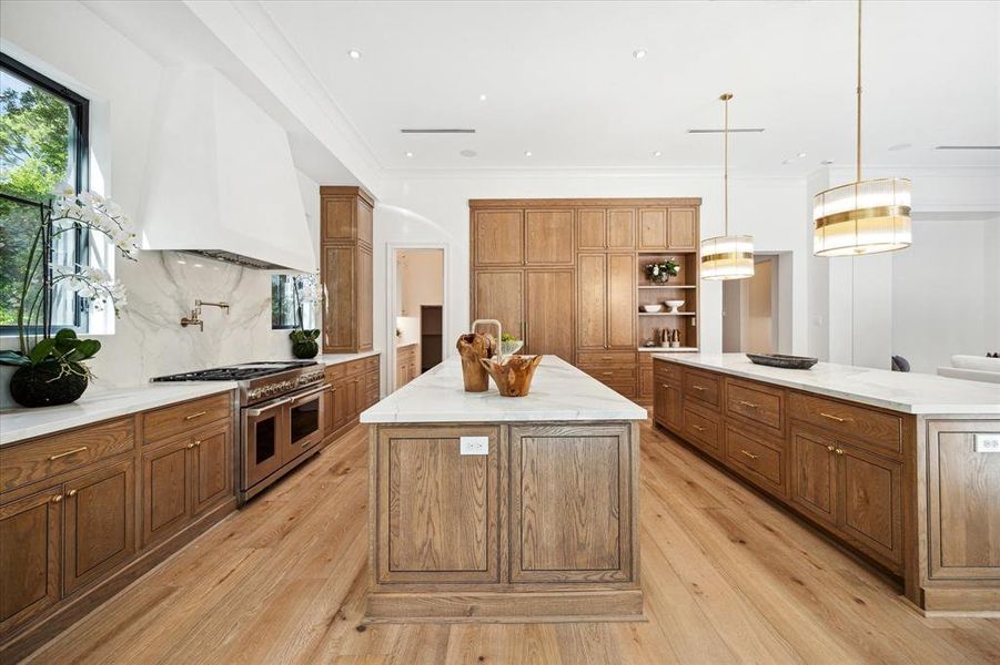 A large butler's pantry complements the kitchen, offering extensive storage to meet all culinary needs. This thoughtful addition keeps the kitchen clutter-free and ensures easy access to essential items.