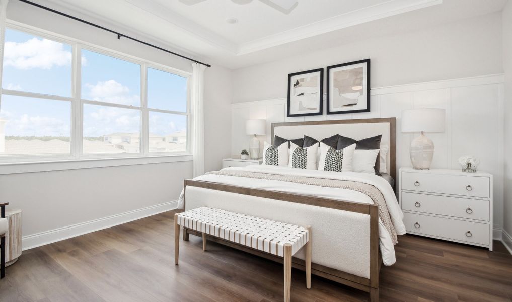 Primary suite with tray ceiling & feature wall