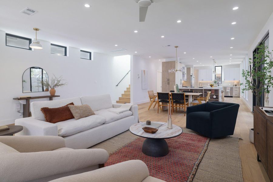 Living area with light wood-type flooring, recessed lighting, and plenty of natural light