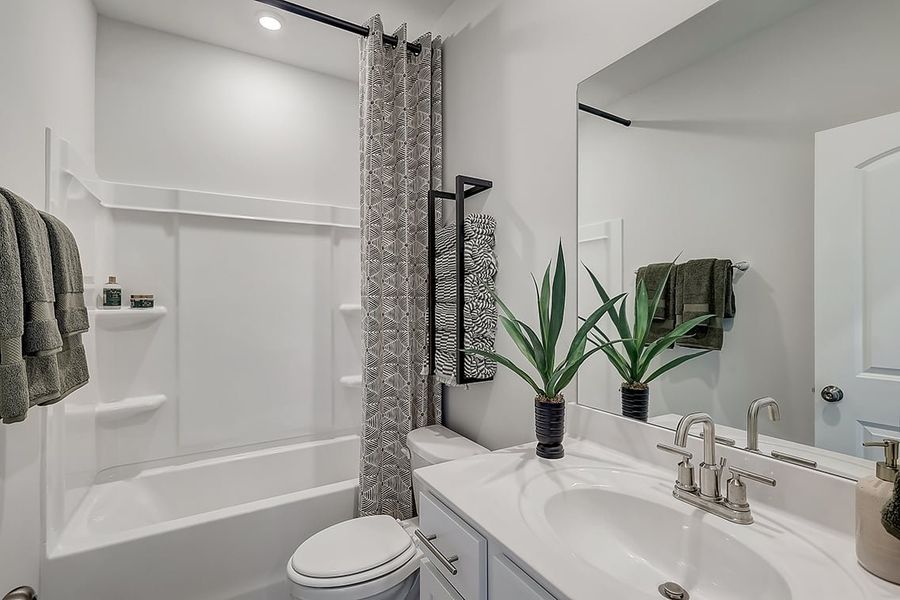A bathroom with a sink and a shower.