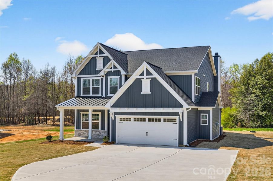 Front exterior of a new home in , Troutman, NC, highlighting curb appeal (Image 26).