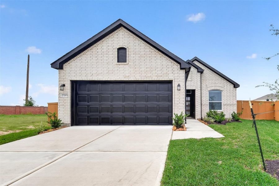 Front exterior of a new home in Sunterra, Katy, TX, highlighting curb appeal (Image 25).