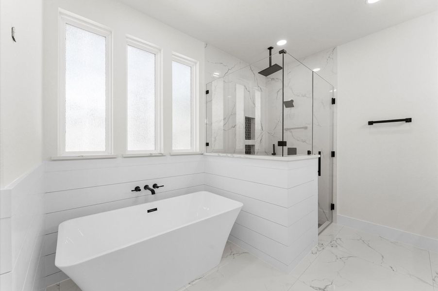 Spa-inspired bath with walk-in shower, soaking tub, double vanities, quartz counters, and luxury finishes. Spa-inspired bath with walk-in shower, soaking tub, double vanities, quartz counters, and luxury finishes.