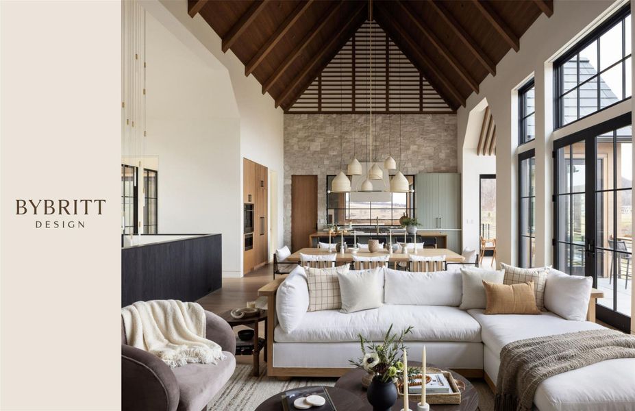Vaulted ceiling with exposed wood beams, stone accent wall, floor-to-ceiling windows, dark wood-finish flooring, and built-in cabinetry
