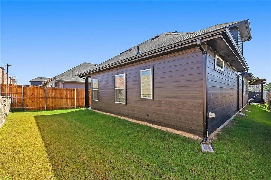 Rear view of house with a lawn