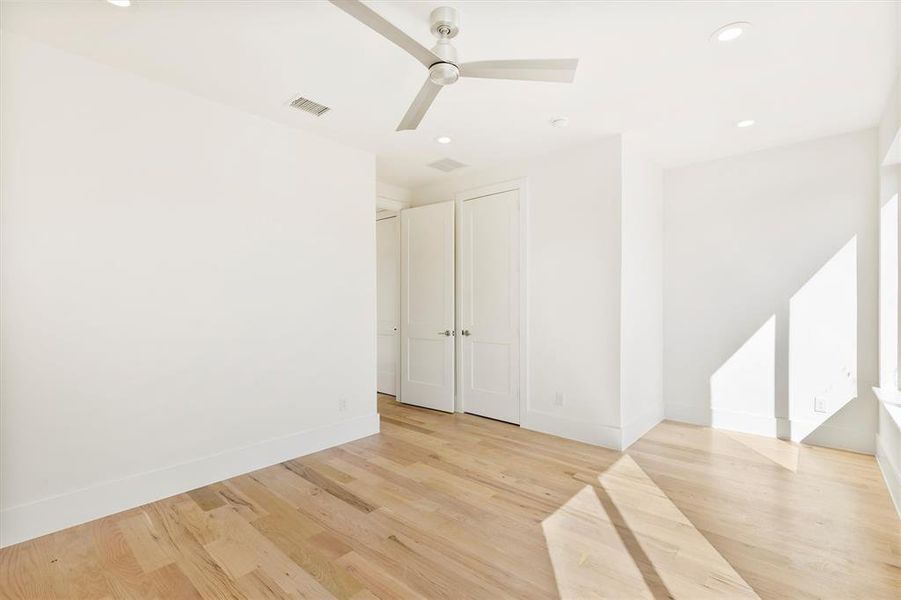 Empty room featuring ceiling fan and light hardwood / wood-style floors