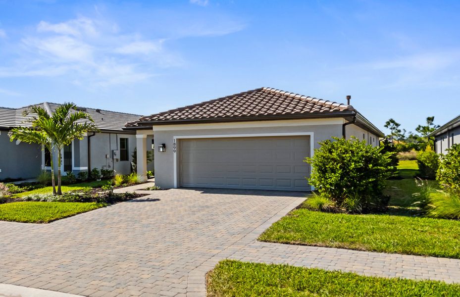 Front exterior of a new home in Terreno, Naples, FL, highlighting curb appeal (Image 2).