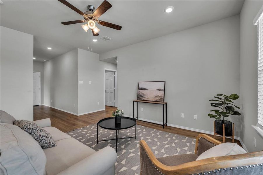 Living room with recessed lighting, ceiling fan, and wood finished floors