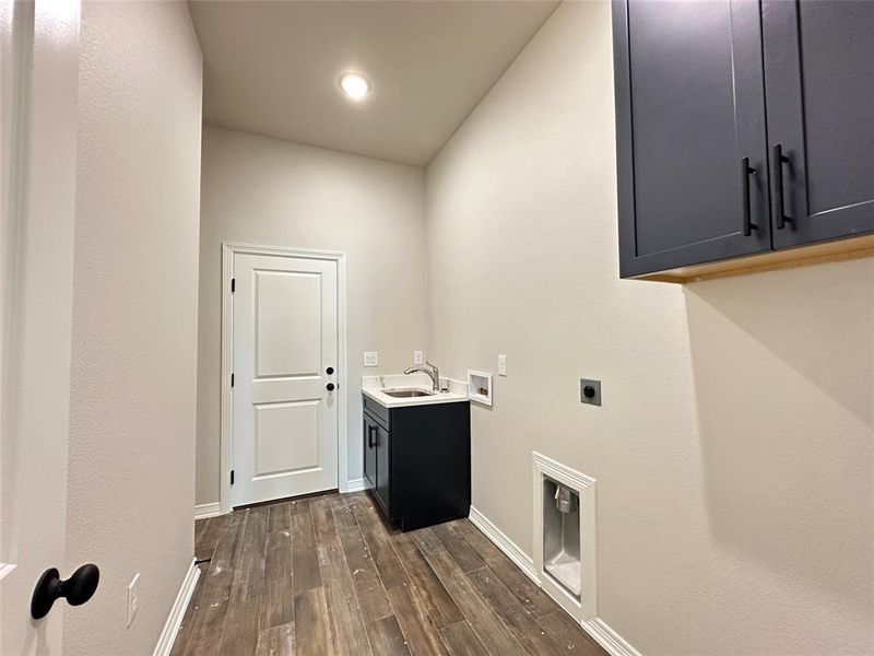 Laundry area with cabinet space, hookup for a washing machine, dark wood-type flooring, electric dryer hookup, and recessed lighting Laundry area with cabinet space, hookup for a washing machine, dark wood-type flooring, electric dryer hookup, and recessed lighting