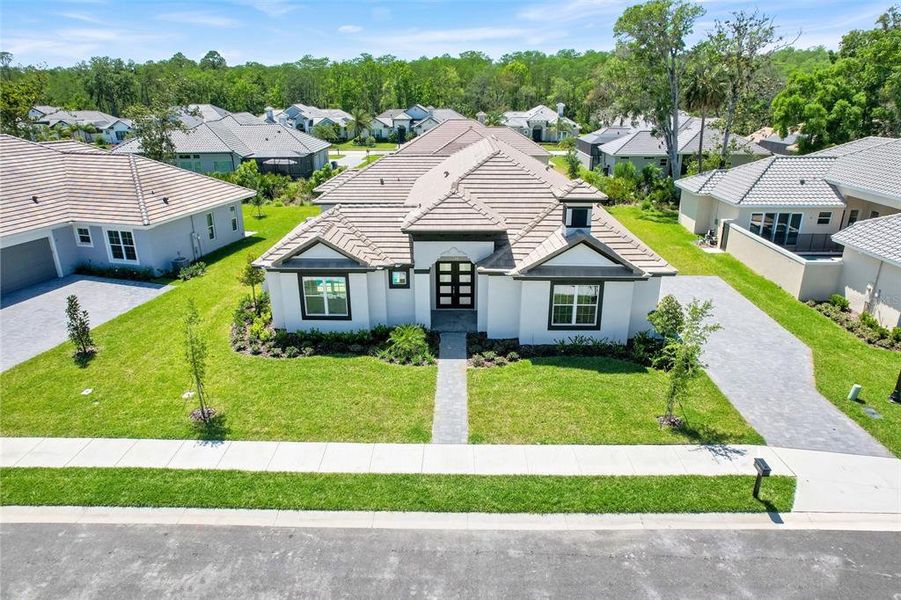 Front exterior of a new home in Toscana, Palm Coast, FL, highlighting curb appeal (Image 23).