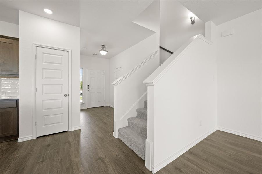 Stairs featuring hardwood / wood-style flooring