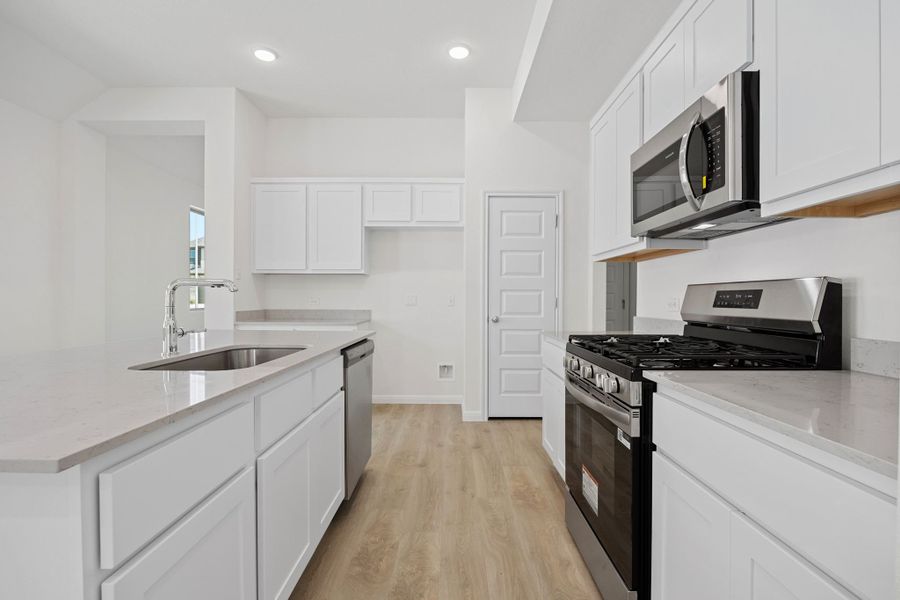 Kitchen in the Elm home plan by Trophy Signature Homes – REPRESENTATIVE PHOTO