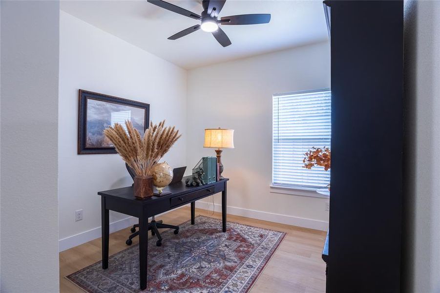 Bedroom with closet / Office with light wood-style flooring and a ceiling fan