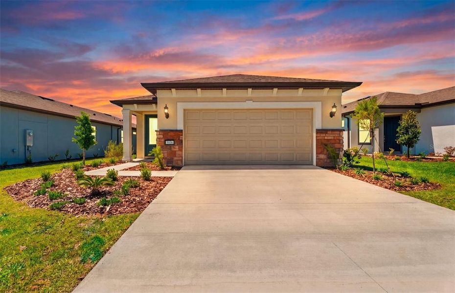 Front exterior of a new home in Del Webb Stone Creek, Ocala, FL, highlighting curb appeal (Image 2). Front exterior of a new home in Del Webb Stone Creek, Ocala, FL, highlighting curb appeal (Image 2).