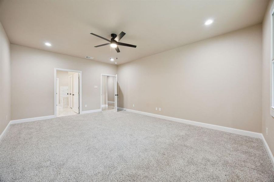 Unfurnished Master bedroom with light carpet, recessed lighting, a ceiling fan, and connected bathroom Unfurnished Master bedroom with light carpet, recessed lighting, a ceiling fan, and connected bathroom