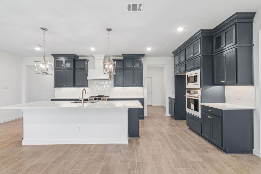 Stylish island kitchen with blue cabinets and quartz counters