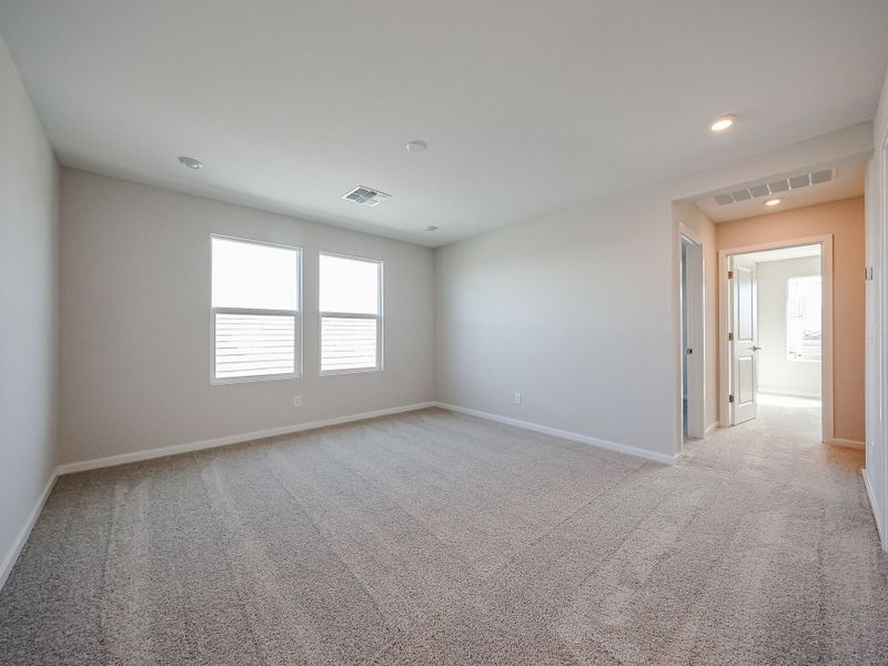 A room with a carpet and windows. A room with a carpet and windows.