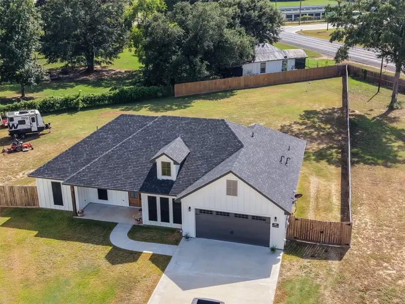 Front exterior of a new home in , Shepherd, TX, highlighting curb appeal (Image 22).