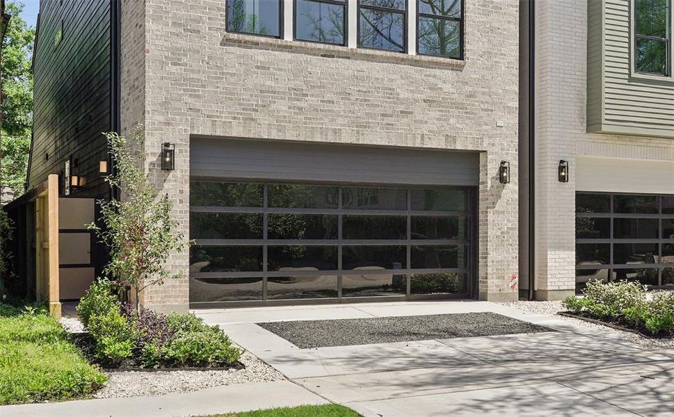 Garage Door with Black Metal Frame and Black Glass.* SELECTIONS MAY VARY * PHOTOS MAY SHOW A SIMILAR FLOOR PLAN AND/OR UPGRADED/ALTERNATIVE FINISHES * Please use these photos as a guide ONLY *