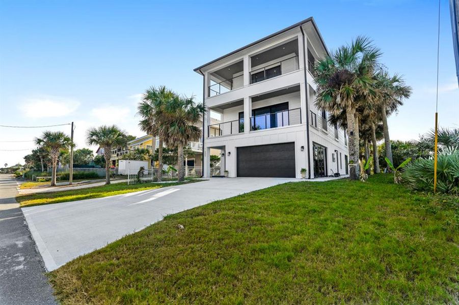 Front exterior of a new home in , Flagler Beach, FL, highlighting curb appeal (Image 23).