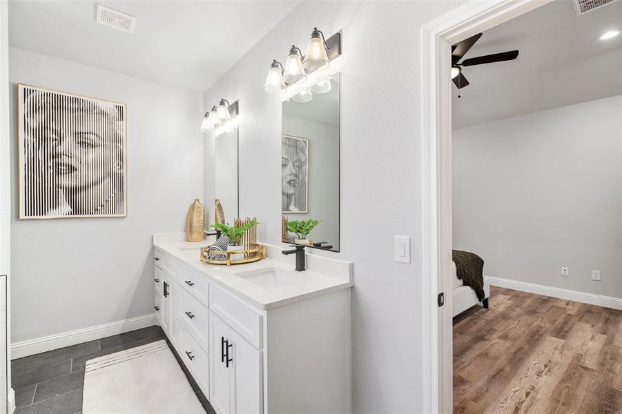 Bathroom with ceiling fan and vanity