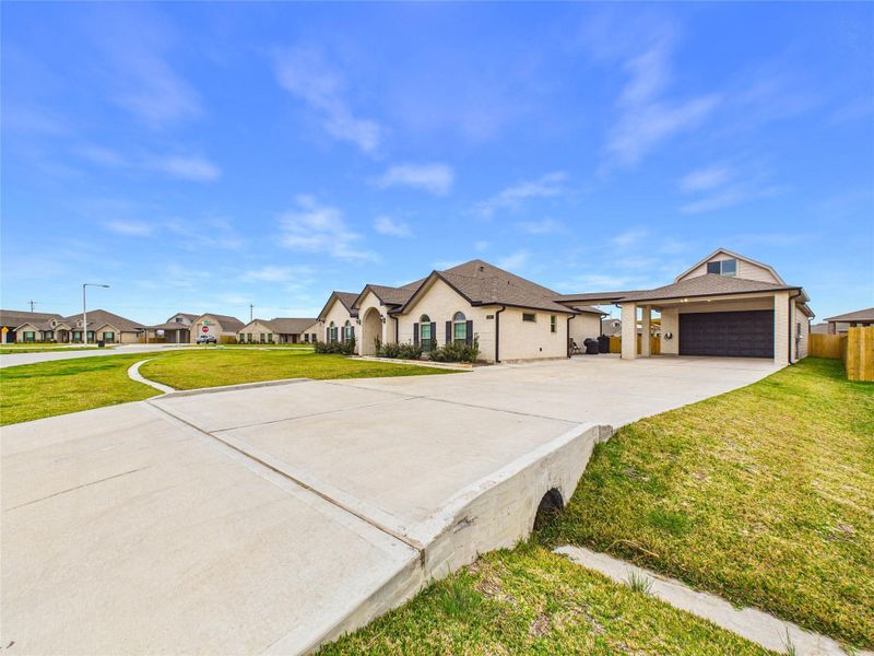 Front exterior of a new home in Pedregal, Galveston, TX, highlighting curb appeal (Image 22).
