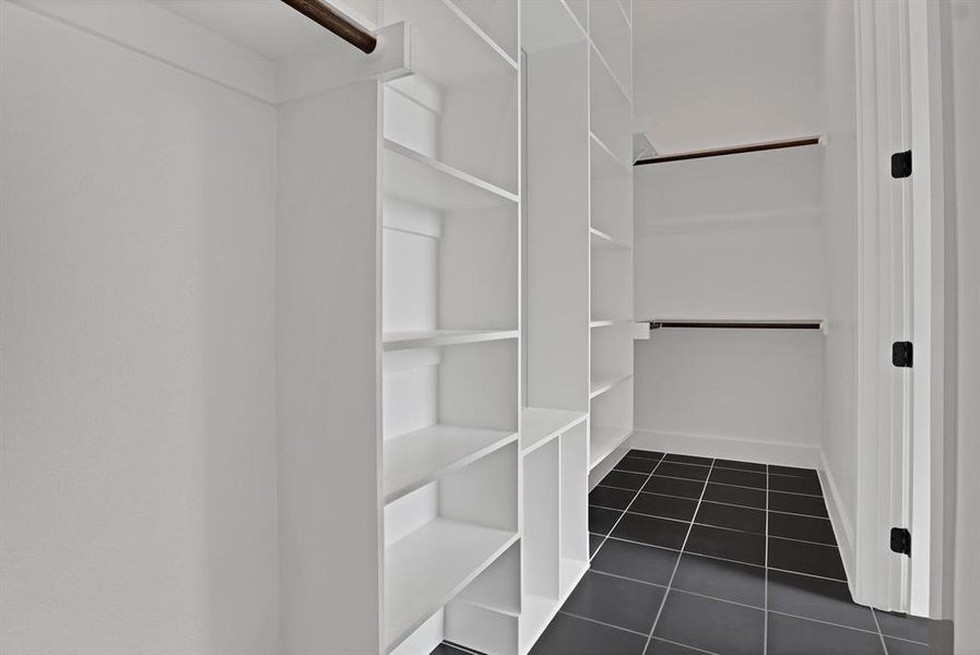 Spacious closet with dark tile patterned flooring