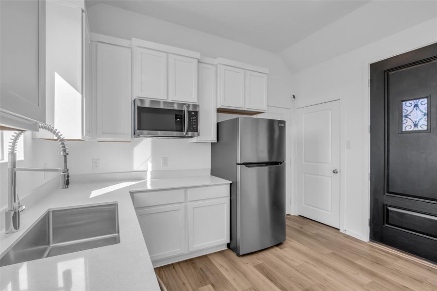 Next Gen Kitchenette & Private Entry:A bright, modern kitchenette anchored by crisp cabinetry, quartz-style counters, and stainless appliances. The private exterior entry and adjacent laundry access reinforce the independence and flexibility of the Next Gen suite. Next Gen Kitchenette & Private Entry:A bright, modern kitchenette anchored by crisp cabinetry, quartz-style counters, and stainless appliances. The private exterior entry and adjacent laundry access reinforce the independence and flexibility of the Next Gen suite.