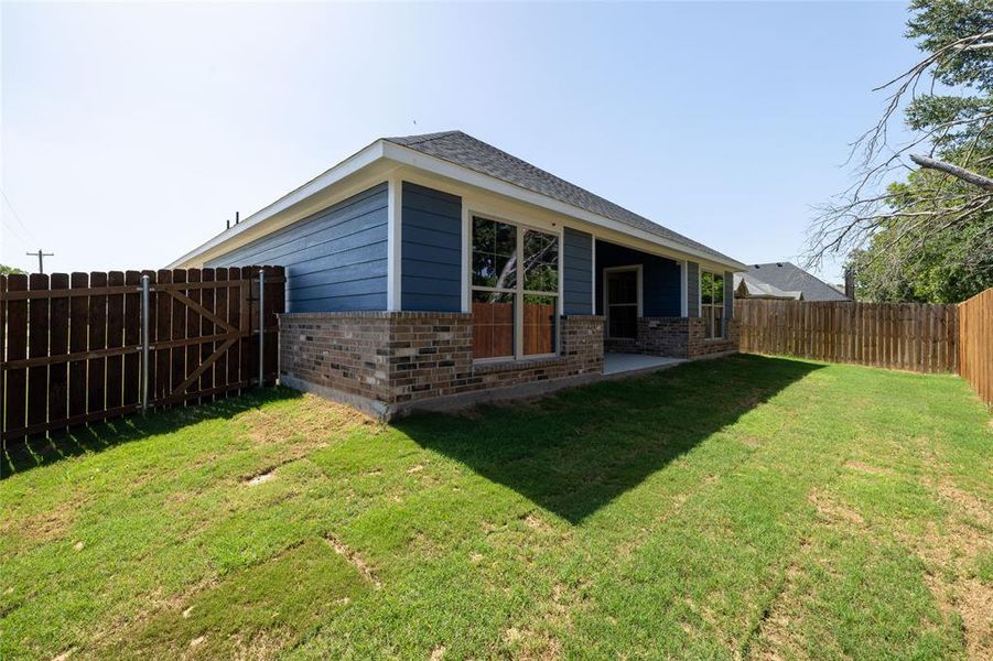 Rear view of property featuring a lawn