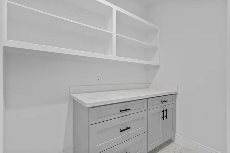Walk in pantry includes more shelving than pictured, and space for a coffee bar.