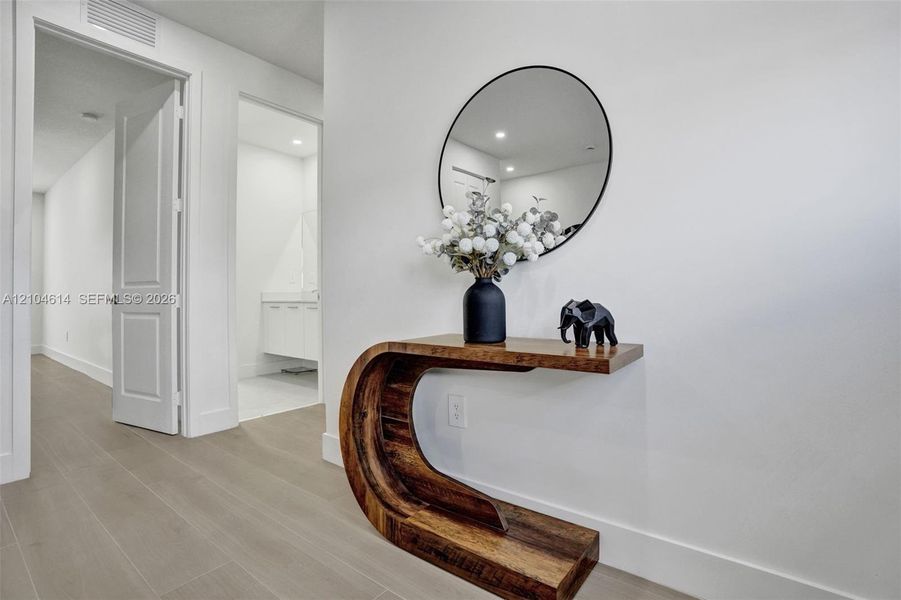 Clean white walls, light wood look flooring, white trim