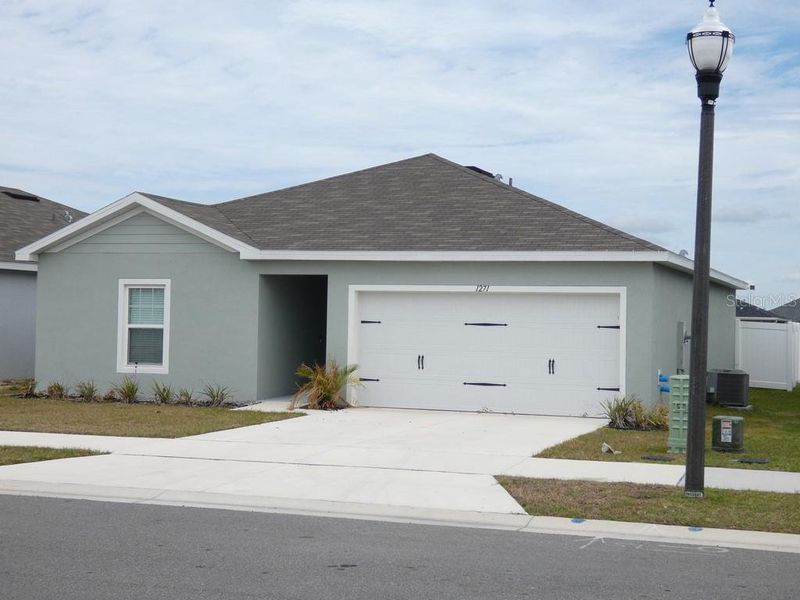 Front exterior of a new home in , Haines City, FL, highlighting curb appeal (Image 22). Front exterior of a new home in , Haines City, FL, highlighting curb appeal (Image 22).