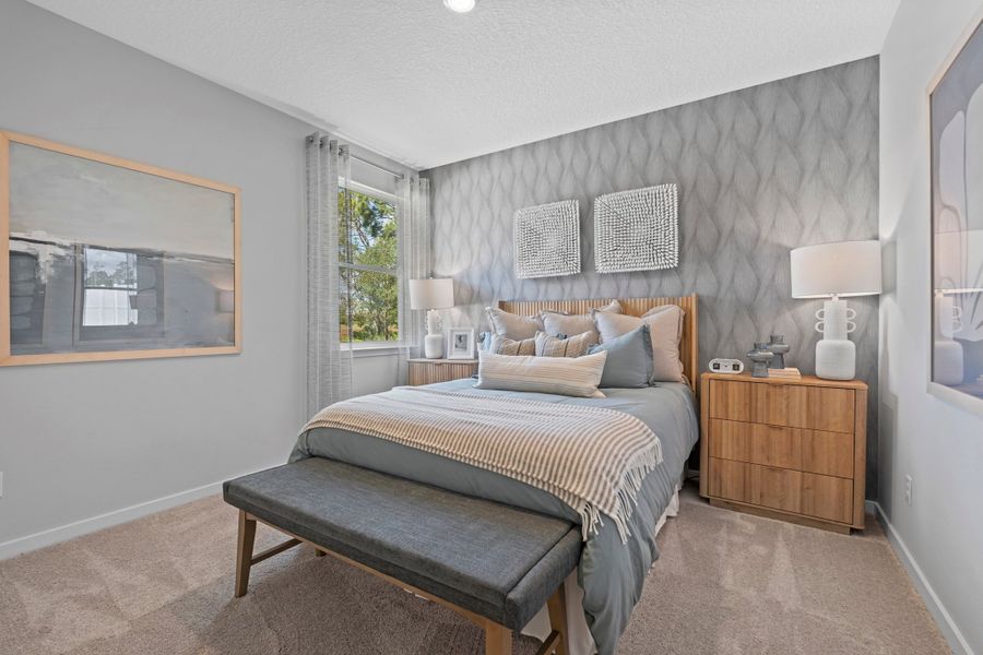 Coronado Model Home Guest Bedroom with Bed and Bench at Reserve East in Flagler Beach Coronado Model Home Guest Bedroom with Bed and Bench at Reserve East in Flagler Beach