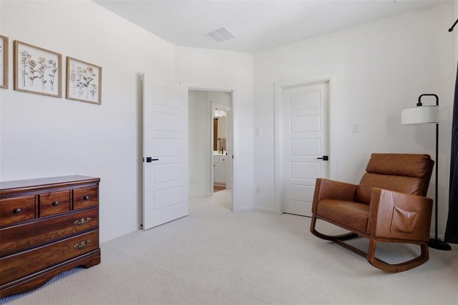 Carpeted room featuring white walls and white five-panel interior doors with matte black hardware Carpeted room featuring white walls and white five-panel interior doors with matte black hardware